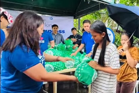SM Supermalls volunteers distribute Kalinga Packs to residents of Barangay Sta. Lucia and Manggahan, Pasig City that were affected by floodings caused by heavy monsoon rains and typhoons ‘Crising,’ ‘Dante’ and ‘Emong,’ during the Operation Tulong Express at the SM City East Ortigas, as shown in a photo posted on 26 July on the mall’s Facebook page. Each Kalinga Pack contains essential goods to help provide immediate relief to affected families.
