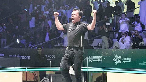 Carlo Biado celebrates his unprecedented 15-13 victory over Fedor Gorst of the United States in the final of the WPA World 9-Ball Championship on Sunday in Jeddah, Saudi Arabia. 