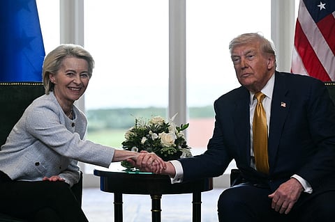 US President Donald Trump (R) shakes hands with European Commission President Ursula von der Leyen (L) after agreeing on a trade deal between the two economies following their meeting, in Turnberry south west Scotland on July 27, 2025, on the third day of his visit to the country, since his second tenure as President began. US President Donald Trump said on July 27, 2025 that he had reached a trade agreement with European Union chief Ursula von der Leyen. "We have reached a deal. It's a good deal for everybody," Trump told reporters after talks with von der Leyen at his golf resort in Turnberry, Scotland. The EU chief also hailed it as a "good deal".

