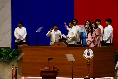 LEYTE First District Representative Martin Romualdez (second from left) takes his oath at the House of Representatives as he retains the chamber’s speakership after 269 members voted for him.