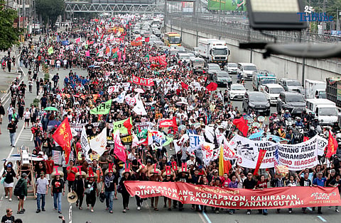 Thousands of protesters from militant groups march along Commonwealth Avenue in Quezon City toward St. Peter Parish Church to stage a SONA protest themed “SONA ng Paniningil,” coinciding with President Ferdinand Marcos Jr.’s fourth State of the Nation Address.