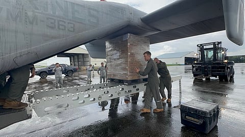 U.S. Marines and Philippine Airmen prepare the delivery of Department of Social Welfare and Development (DSWD) family food packs at Clark Air Base. 