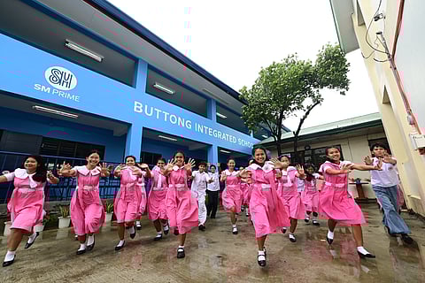 STUDENTS and teachers of Buttong Integrated School welcome their new SM-donated classrooms with joy and pride.