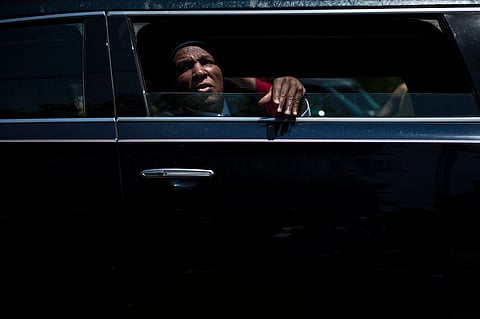 Rahaman Ali rides in procession with the remains of his brother boxing legend Muhammad Ali as it travels to Cave Hill Cemetery June 10, 2016 in Louisville, Kentucky. Thousands of people from near and far were expected to line the streets of Muhammad Ali's hometown Louisville on Friday to say goodbye to the boxing legend and civil rights hero, who mesmerized the world with his dazzling skills.
