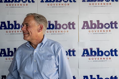 (FILES) KATY, TEXAS - OCTOBER 27: Texas Gov. Greg Abbot waits to take pictures with supporters at the conclusion of a 'Get Out The Vote' rally at the Fuzzy's Pizza & Italian Cafe on October 27, 2022 in Katy, Texas. 
