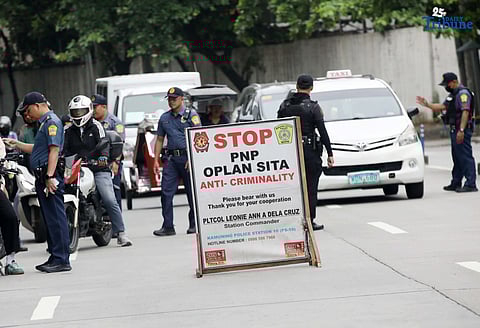 Quezon City Police District (QCPD) Station 10 personnel conduct a checkpoint along NIA Road, Quezon City, on Wednesday, August 6, 2025, as part of the Philippine National Police’s “Plan Sita” anti-criminality operations. According to the QCPD, crime volume in the city dropped by at least 25 percent in the past three months, with 394 recorded incidents from April 21 to July 20, compared to 526 during the same period last year.