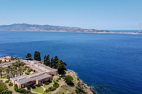 A general aerial view shows the Sicilian coast towards Cape Torre Faro, over the Strait of Messina, taken from the outskirts of the town of Scilla, in Calabria region in southern Italy, on July 7, 2020. Italy's government on August 6, 2025 approved a 13.5-billion-euro ($15.6-billion) project to build the world's longest suspension bridge connecting the island of Sicily to the mainland.