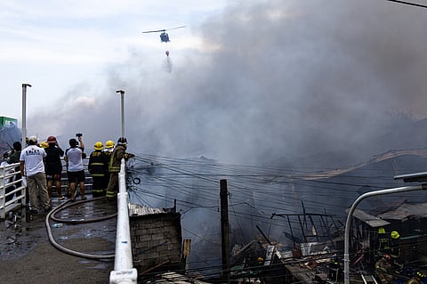 Firefighters race against time to douse the blaze that razed Aroma Compound residences in Tondo, Manila on Wednesday. 