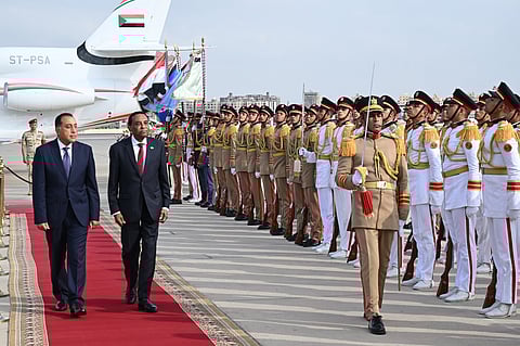 Egypt's Prime Minister Mostafa Madbouly (L) welcomes his counterpart from Sudan Kamil Idris upon his arrival at the Cairo International airport in Egypt's capital on August 7, 2025.
Sudan's army-aligned prime minister arrived in Cairo on August 7 morning, for his first official foreign visit since assuming office in May, as his country remains gripped by a brutal war, now in its third year.
