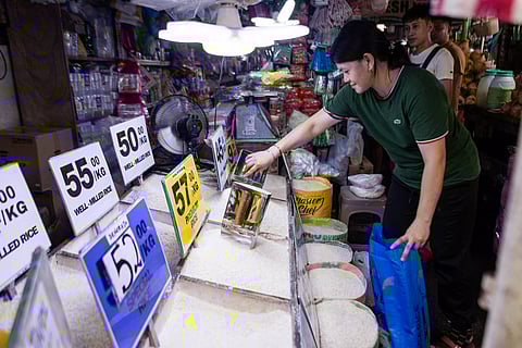 Spike in rice prices A vendor scoops rice at a Manila market as concerns grow over a 60-day rice import suspension starting 1 September. Stakeholders warned the ban could increase retail rice prices, citing reduced imported supply and rising local palay prices.