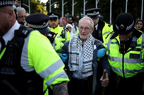 A protester is led away by police officers at a "Lift The Ban" demonstration in support of the proscribed group Palestine Action, calling for the recently imposed ban to be lifted, in Parliament Square, central London, on August 9, 2025. Organisers expect at least 500 people to turn up to a new demonstration in support of Palestine Action today, and police have warned all demonstrators could face arrest. Palestine Action was proscribed under the 2000 Terrorism Act.
