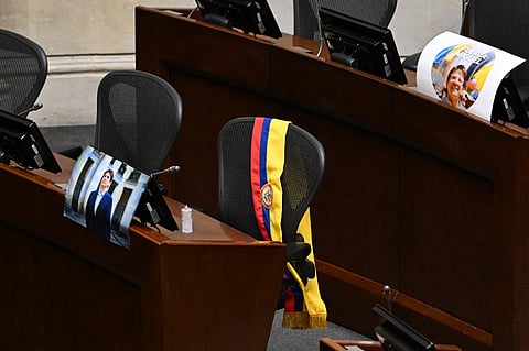 A picture of Colombian presidential candidate Miguel Uribe and his sash are displayed at his seat in Congress in Bogota on August 11, 2025. Colombian presidential candidate Miguel Uribe died two months after being shot in the head at a campaign event, his wife announced early August 11, 2025. The legislator's condition had returned to critical after he suffered a new brain hemorrhage related to the assassination attempt during a rally on June 7, in which he was shot three times, twice in the head.
