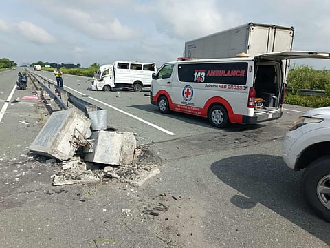 An ambulance from the Philippine Red Cross responds to a road accident involving an L300 mini-truck along the Central Luzon Expressway in La Paz, Tarlac. The incident left five dead and nine injured. 