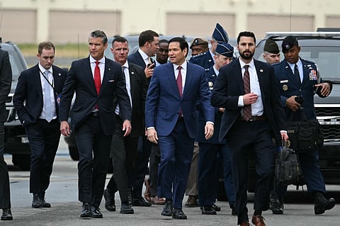US Defense Secretary Pete Hegseth (C, L) and Secretary of State Marco Rubio (C, R) walk on the tarmac upon arrival at Joint Base Elmendorf-Richardson in Anchorage, Alaska, on August 15, 2025. US President Donald Trump is in Anchorage for a summit with Russian leader Vladimir Putin.
