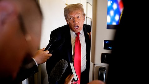 U.S. President Donald Trump speaks to members of the media aboard Air Force One on August 15, 2025, in flight. President Trump is traveling to Anchorage, Alaska, for peace talks with Russian President Vladimir Putin on the war with Ukraine. 