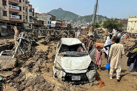PEOPLE eople gather near a damaged vehicle and scattered debris after the road washed out following a flash flood in Mingora, the main city of Swat Valley, in monsoon-hit northern Pakistan's mountainous Khyber Pakhtunkhwa province on August 16, 2025. The death toll from heavy monsoon rains that have triggered flash floods across northern Pakistan has risen to at least 321 people in the last 48 hours, disaster agencies said on 16 August.