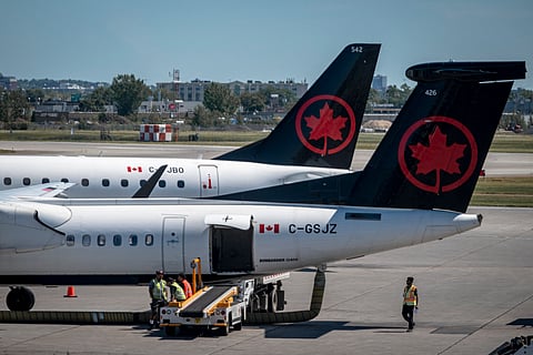 TWO Air Canada planes are seen on the tarmac of the Pierre-Elliot Trudeau Airport in Montreal, Quebec, Canada, on August 15, 2025. Air Canada began cancelling flights on August 14 after receiving a strike notice from the flight attendants' union, warning all operations could be shut down by Saturday. The airline that transports about 130,000 passengers daily announced this week that negotiations on a new collective agreement with its 10,000 flight attendants had reached an "impasse."