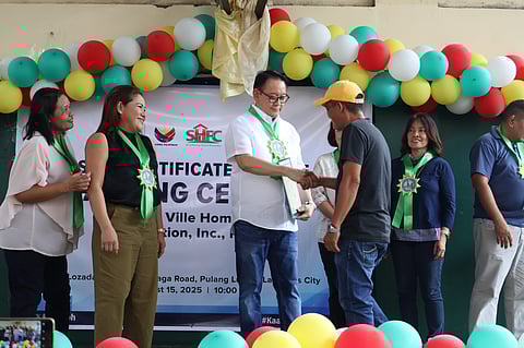 SOCIAL Housing Finance Corporation president and CEO Federico Laxa leads the distribution to 80 beneficiaries of land ownership in Las Piñas City.