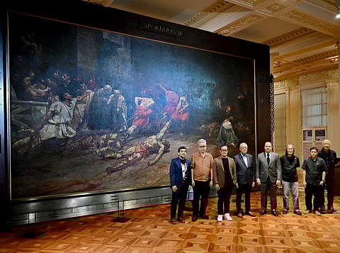 Larger than life BSP Governor Eli M. Remolona Jr. and National Museum of the Philippines chairperson Andoni M. Aboitiz (fourth and fifth from left, respectively) with some of the featured artists in the exhibit: (from left) artists Joey Cobcobo, Gerardo Tan, Demi Padua, Junyee, Melvin Culaba and Charlie Co stand before the impressive Spoliarium, a masterpiece of Philippine hero Juan Luna.