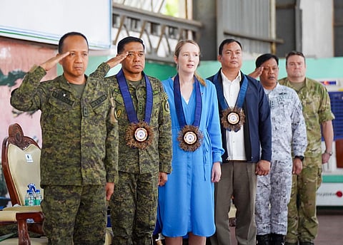 (From left) Commander of Armed Forces of the Philippines Education, Training and Doctrine Command MGen Francisco F Lorenzo Jr., AFP Chief of Staff General Romeo S Brawner Jr, Deputy Ambassador of Australia to the Philippines Dr Moya Collett, Acting Head of DFA Consular Office in Puerto Princesa Donald D. Ocampo, VAdm Alfonso F Torres Jr., Commander of Western Command, and Deputy Chief of Joint Operations MGen Hugh McAslan sing the Philippine national anthem marking the opening ceremony of Exercise ALON 2025.