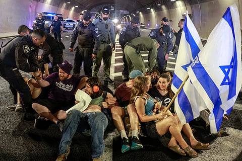 ISRAELI police remove demonstrators blocking traffic in a tunnel, as families and supporters of Israelis held hostage by Hamas militants in Gaza since the 7 October 2023 attacks, stage a protest calling for government action to secure their release in Jerusalem on 17 August 2025. 
