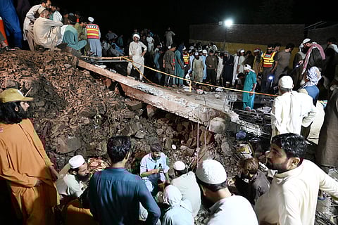 RESCUE workers and residents search for victims in the debris of collapsed houses after a cloudburst in Dolari village, Swabi district, in northern Pakistan’s mountainous Khyber Pakhtunkhwa province. Fresh torrential rains in northern Pakistan killed at least 20 people, local officials said, as the region is ravaged by an unusually intense monsoon season that has left more than 300 people dead in recent days.