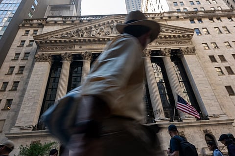 NEW YORK, NEW YORK - AUGUST 12: People walk by the New York Stock Exchange (NYSE) on August 12, 2025 in New York City. Stocks surged nearly 500 points on Wall Street as investors saw new economic data that showed consumer prices matched expectations. 
