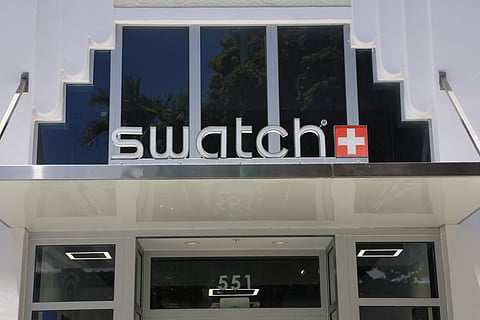 A sign hangs over the entrance to a Swatch store on August 05, 2025 in Miami Beach, Florida. U.S. President Donald Trump announced that Swiss goods will be hit with a 39 percent tariff in the United States on August 7. 