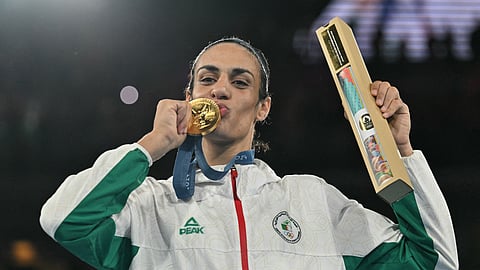 Gold medallist Algeria's Imane Khelif poses on the podium during the medal ceremony for the women's 66kg final boxing category during the Paris 2024 Olympic Games at the Roland-Garros Stadium, in Paris on August 9, 2024.
