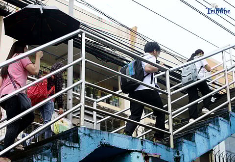 Students at Corazon Elementary School in Quezon City wear protective gear against the rain as they attend classes on Friday, August 22 2025. Unlike other cities that announced class suspensions due to continuous rain from TD Isang, Quezon City did not issue any cancellations.