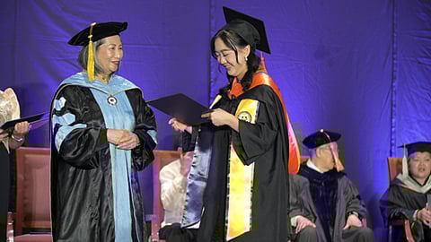 JUBILANT Marjorie Co (right) accepts her diploma from APC president Dr. Tata Medado.