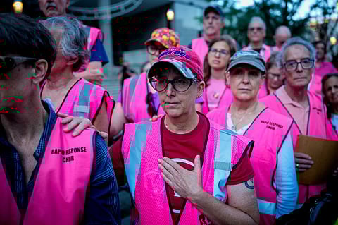 BALTIMORE, MARYLAND - AUGUST 25: Members of the Rapid Response Choir participate in a prayer vigil for Kilmar Abrego Garcia before he enters a U.S. Immigration and Customs Enforcement (ICE) field office on August 25, 2025 in Baltimore, Maryland. Three days after being released, Garcia has been detained again, as the U.S. Government is threatening to deport Garcia, a Maryland construction worker from El Salvador, to Uganda after he rejected a plea deal to be charged with Human Smuggling and deported to Costa Rica. Earlier this year Garcia was wrongfully deported to a notorious anti-terrorism prison CECOT in El Salvador. 
