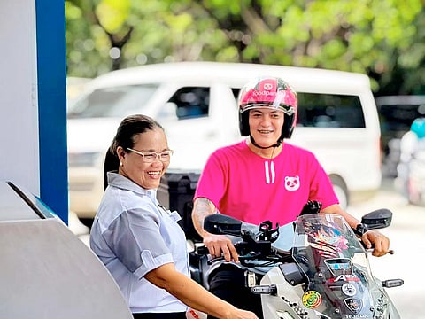 A FOODPANDA rider avails of the P10-per-liter fuel discount at a Caltex station under the Ka-panda Gasolinahan program.