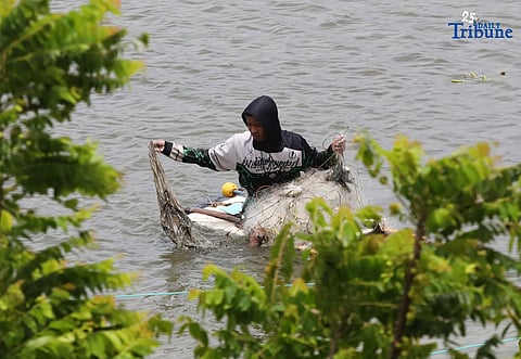 A man riding a makeshift styrofoam boat is seen fishing in Tanza, Navotas City on Thursday, 28 August 2025. 
