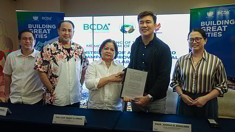 Pampanga Governor Lilia “Nanay” Piñeda shakes hands with BCDA President and CEO Joshua Bingcang during the signing of a Memorandum of Agreement for the construction of an access road to Pampanga Provincial Hospital–Clark. The MOA signing was done at the Royce Hotel in Clark Freeport on August 28, 2025.