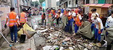 Bayanihan in action Residents of Barangay San Antonio, Quezon City join forces to clear streets clogged with debris after a sudden, Ondoy-like downpour flooded their neighborhood on Saturday.