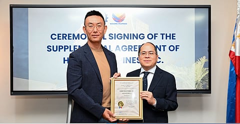 PEZA Director General Tereso Panga and HPI Corporate Secretary Mitchell Estacio show the Supplemental Agreement to reclassify HPI's Hann Reserve property to a mixed-use Special Economic Zone encompassing Manufacturing, Agro-Industrial, Tourism, and Information Technology sectors