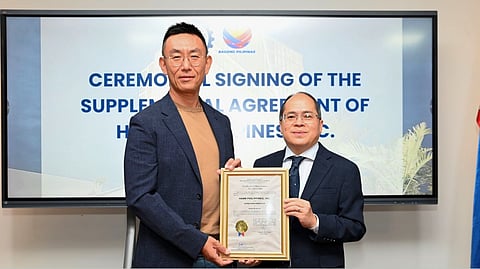 PEZA director general Tereso Panga (right) and HPI corporate secretary Mitchell Estacio show the supplemental agreement to reclassify HPI’s Hann Reserve property to a mixed-use Special Economic Zone encompassing manufacturing, agro-industrial, tourism and information technology sectors.