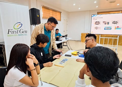 A First Gen employee (third from left) helps a team of students visualize and simplify their ideas about climate change and the environment during the ‘Youth for Climate and Energy Leadership Summit.’