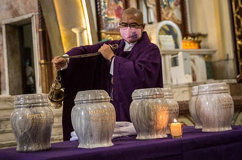 Fr. Flaviano Lopez Villanuvea is incensing the remains of EJK victims' urns (Photo courtesy of Fr. Flavie Villanueva Facebook)