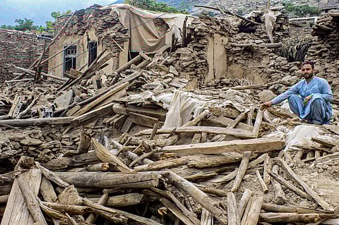 An Afghan man sits amid the remains of a damaged house, in the aftermath of an earthquake at the Dara-i-Nur district of Nangarhar province on September 3, 2025. Hope was quickly fading of finding survivors in the rubble of homes devastated by the weekend's powerful 6.0-magnitude quake in eastern Afghanistan, as emergency services struggled to reach remote villages on September 3.
