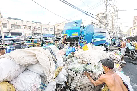 VENDORS and workers join forces to clear piles of rejected vegetables, fruits and other debris along Recto Avenue in Divisoria, a familiar sight after a busy market day.