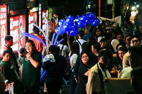 Friends and family of the 2025 Bar Exam participants gather outside the gates of the University of Santo Tomas in Manila to cheer on and show their support their respective loved ones who are taking the tests.