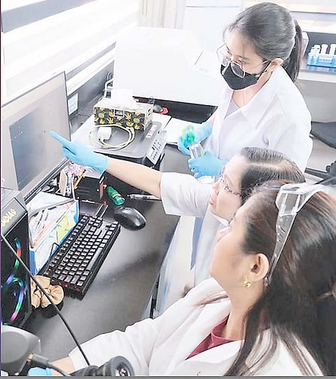 Angelo Mark P. Walag (right, inset) and students play a card game for learning quantum chemistry while Professor Mylene M. Uy (middle) mentors at the Mindanao State University-Iligan Institute of Technology. 