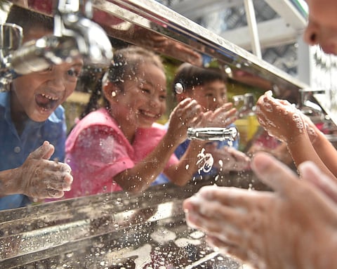 STUDENTS at Lucena South Elementary School in Quezon Province wash their hands with clean water produced by an AquaTower filtration system from Planet Water Foundation. 