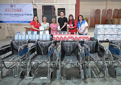 Officials from the Philippine Charity Sweepstakes Office turn over medical equipment and wheelchairs to the Lucena City local officials. The donated equipment will be given to the city’s residents.
