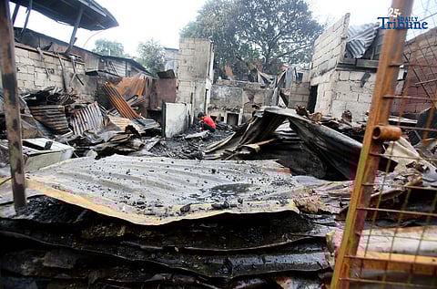 Fire victims sift through what remains of their belongings after a fifth-alarm blaze struck a residential area in Sitio Mabilog, Barangay Culiat, Quezon City, on Tuesday evening, September 9.