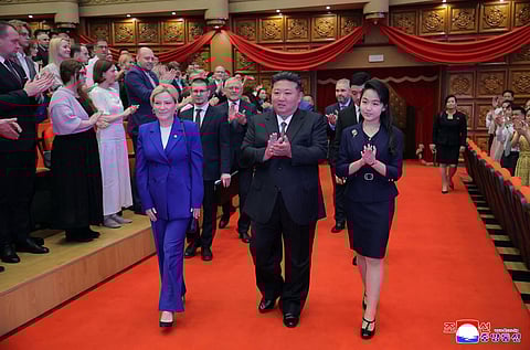 This picture taken on June 29, 2025 and released by North Korea's official Korean Central News Agency (KCNA) on June 30, 2025 shows North Korean leader Kim Jong Un (C) and his daughter Kim Ju-ae (R) entering with Russian Minister of Culture Olga Lyubimova (L) to watch a performance by Russian and North Korean entertainers at the East Pyongyang Grand Theatre in Pyongyang.
