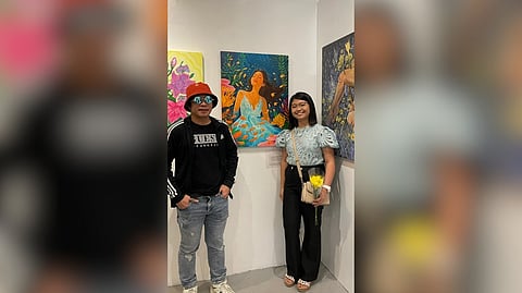 Abe Orobia with Jessa Desoloc and her artwork at the 'Symbiosis' exhibition at J Studio in Chino Roces, Makati.