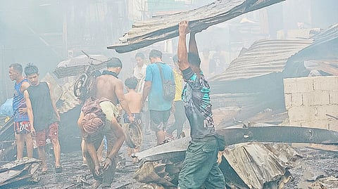Residents of Happy Land in Tondo, Manila try to salvage what they can after a blaze razed their residences Saturday night up until Sunday morning.